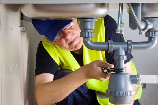 Professional plumber working